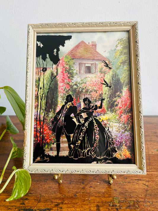 Reverse Painted Silhouette Lithograph Picture on Glass - Courting Couple in Beautiful Flower Garden with Country Cottage