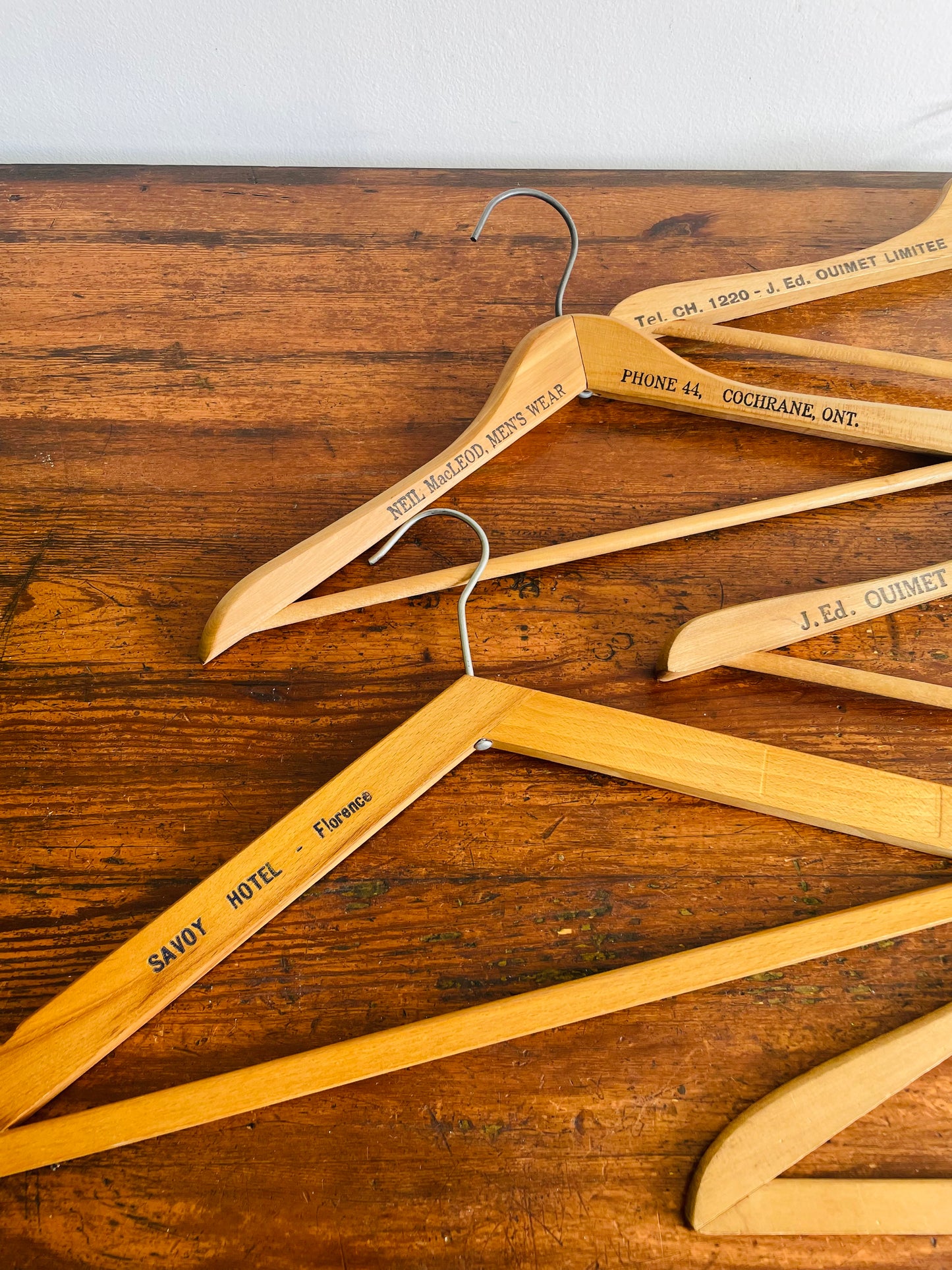 Instant Collection of 12 Wood & Metal Clothes Hangers Stamped with Advertising Slogans