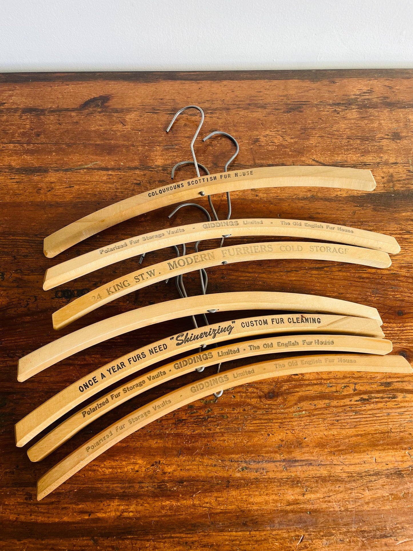 Instant Collection of 12 Wood & Metal Clothes Hangers Stamped with Advertising Slogans