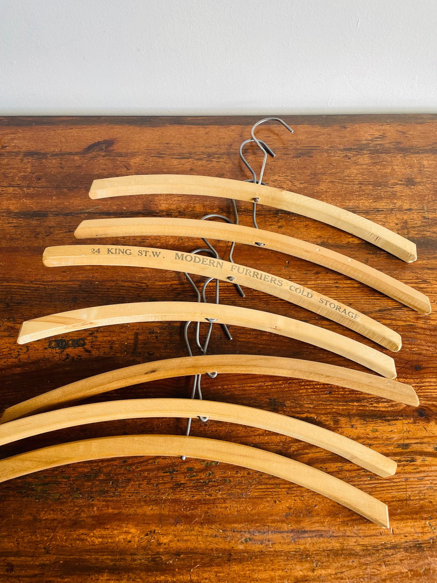 Instant Collection of 12 Wood & Metal Clothes Hangers Stamped with Advertising Slogans